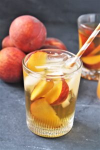 This Peach and Ginger Iced Tea combines freshly brewed green tea and a flavored simple syrup made with fresh peaches and ginger, perfect for warm weather sipping!