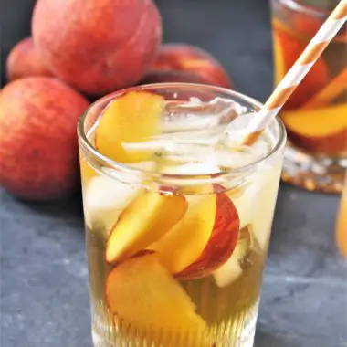 This Peach and Ginger Iced Tea combines freshly brewed green tea and a flavored simple syrup made with fresh peaches and ginger, perfect for warm weather sipping!
