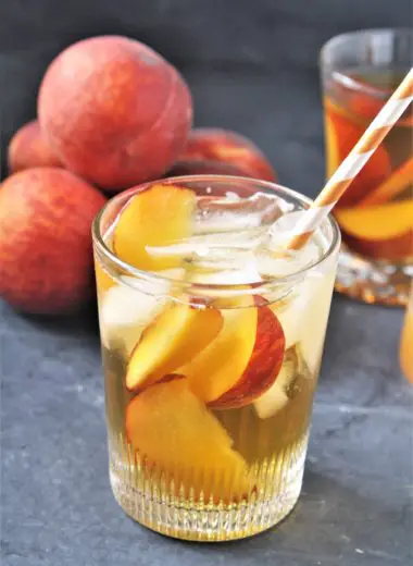 This Peach and Ginger Iced Tea combines freshly brewed green tea and a flavored simple syrup made with fresh peaches and ginger, perfect for warm weather sipping!