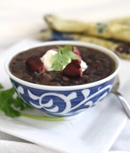 Cuban Black Bean Soup with Smoked Ham Hock is made with black beans simmered with smoked ham hocks and aromatic ingredients like onions, garlic, bell peppers, and spices. The infusion of flavors creates a deeply satisfying and robust soup.