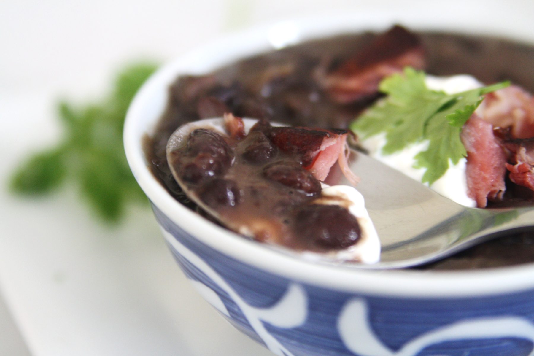 Cuban Black Bean Soup with Smoked Ham Hock is made with black beans simmered with smoked ham hocks and aromatic ingredients like onions, garlic, bell peppers, and spices. The infusion of flavors creates a deeply satisfying and robust soup.