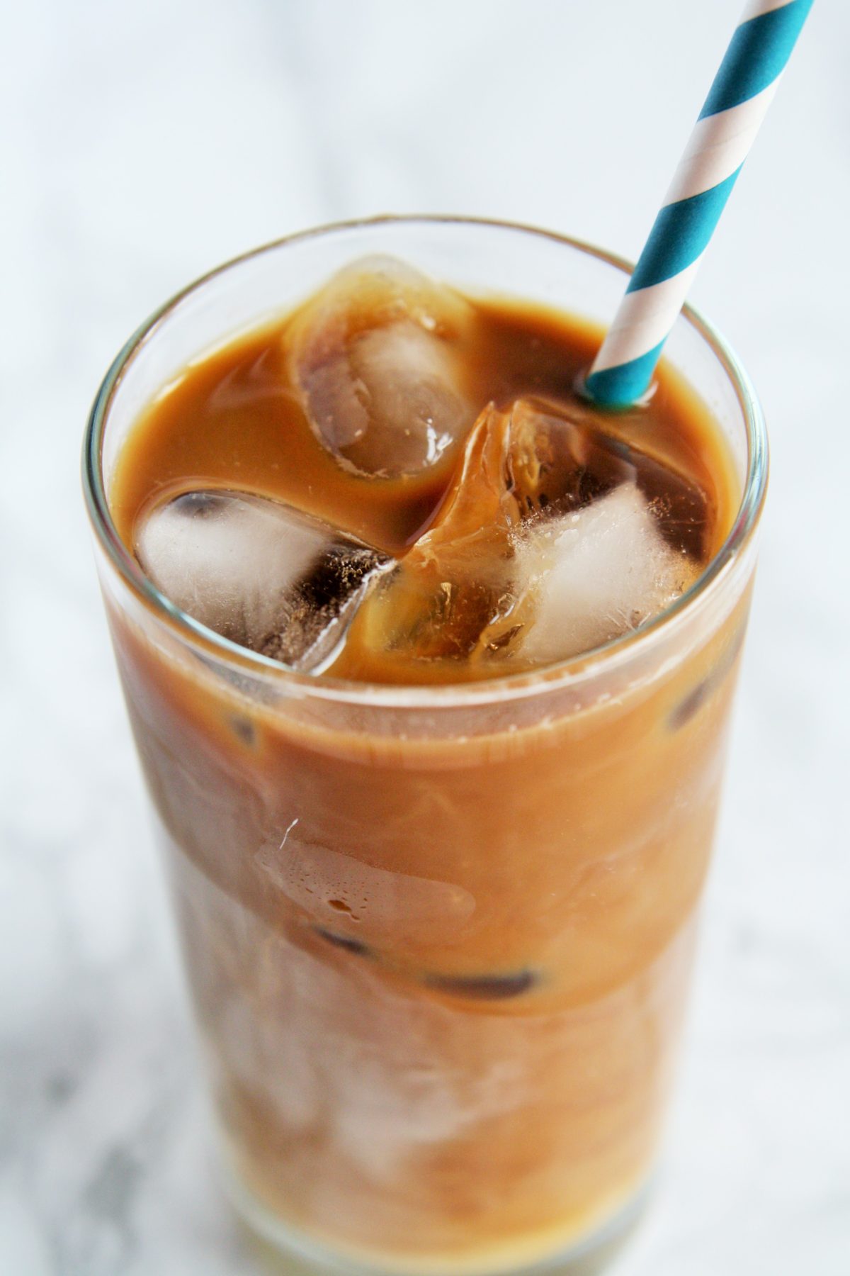 Cold brewed iced latte coffee on plastic cup, side view with