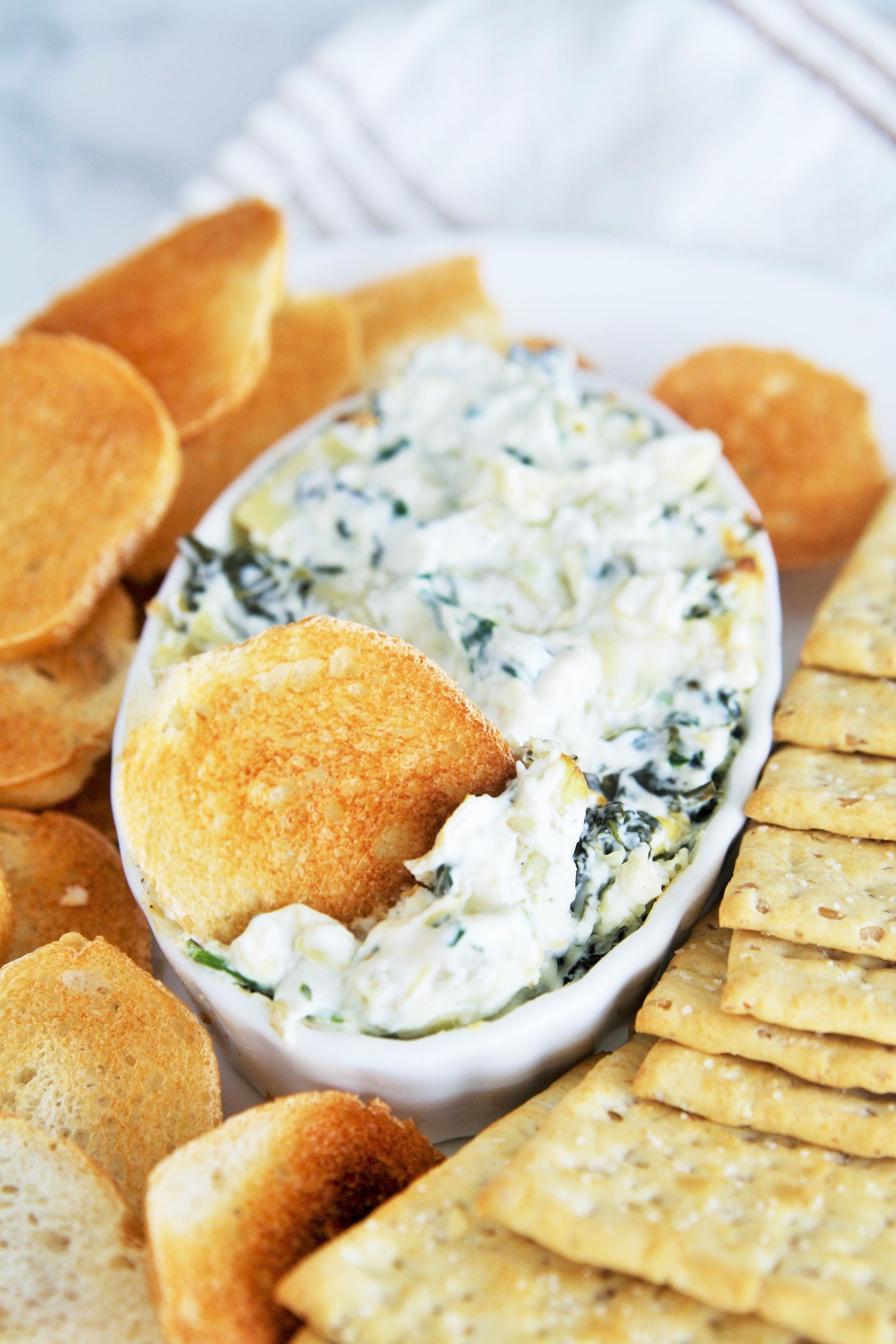 Spinach and artichoke dip is always a crowd pleaser, and this Cheesecake Factory copycat hot spinach and cheese dip is a delicious and easy appetizer you can make at home!