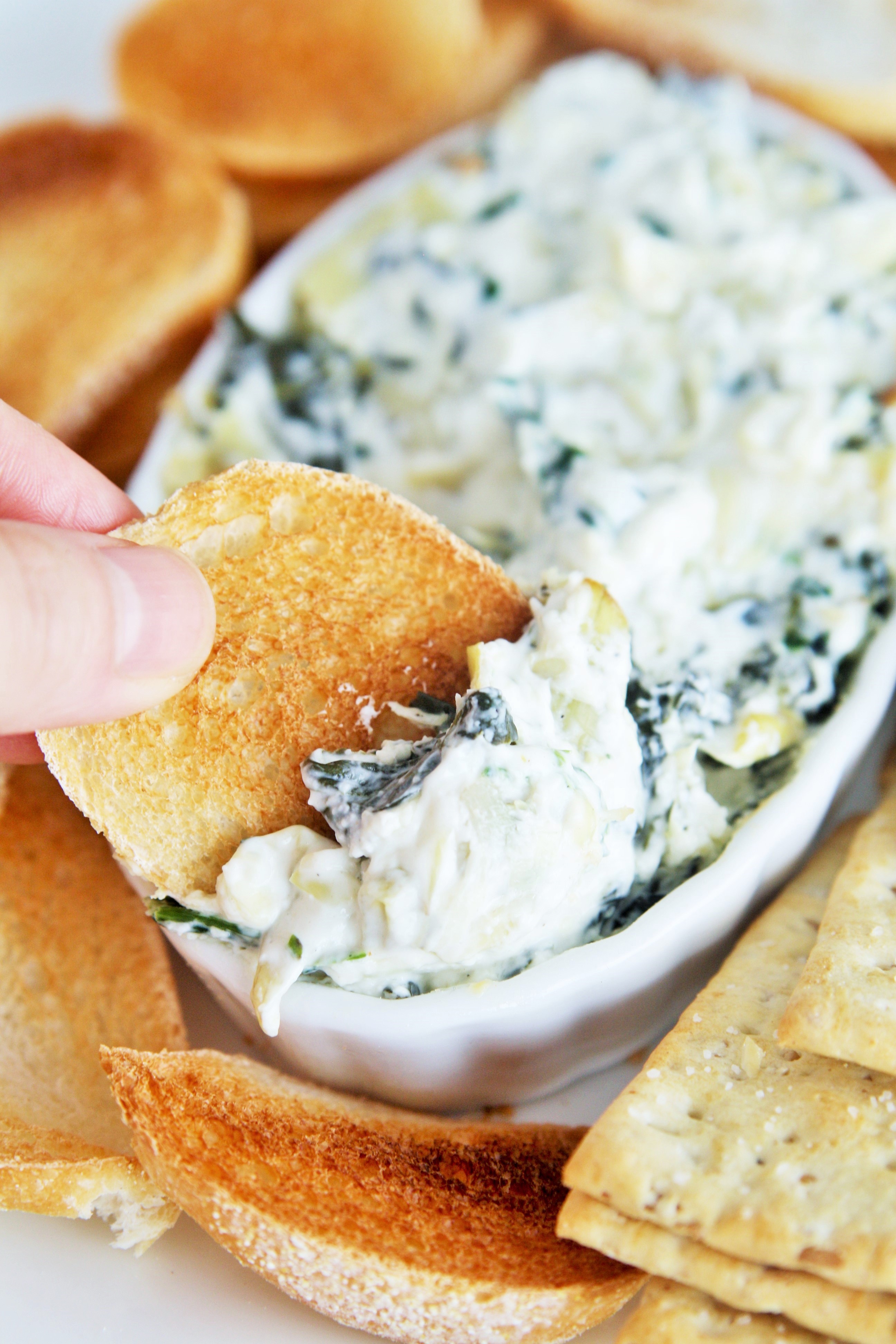 Spinach and artichoke dip is always a crowd pleaser, and this Cheesecake Factory copycat hot spinach and cheese dip is a delicious and easy appetizer you can make at home!