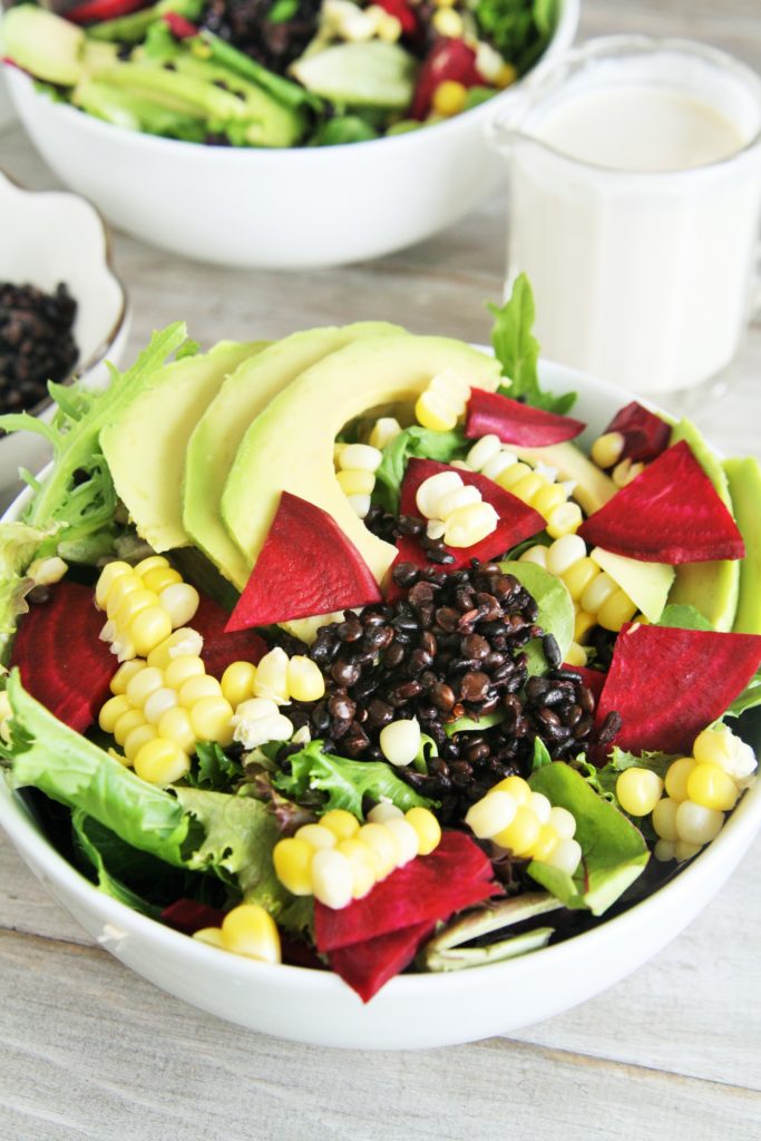 This delicious salad is loaded with superfood ingredients such as avocado, corn, beets, and baby spinach tossed in a creamy lemon tahini dressing - light yet hearty enough for lunch or dinner!