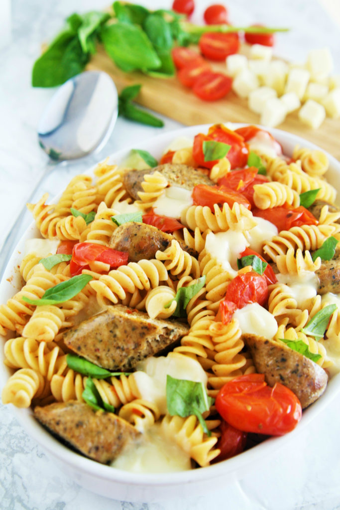 Fresh tomatoes, basil, and mozzarella cheese come together with chicken sausage in a pasta dish that is ready in under 30 minutes -- perfect for busy weeknights!