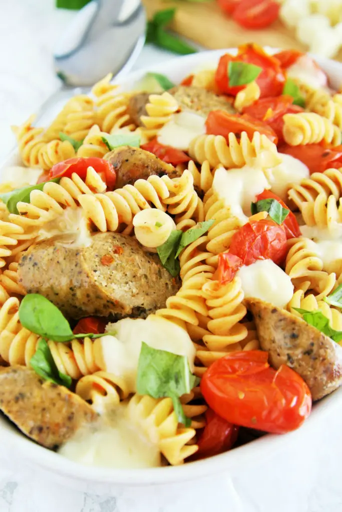 Fresh tomatoes, basil, and mozzarella cheese come together with chicken sausage in a pasta dish that is ready in under 30 minutes -- perfect for busy weeknights!