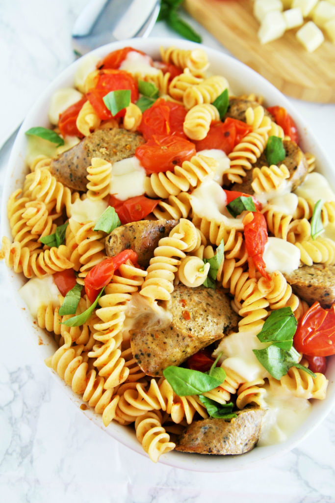 Fresh tomatoes, basil, and mozzarella cheese come together with chicken sausage in a pasta dish that is ready in under 30 minutes -- perfect for busy weeknights!