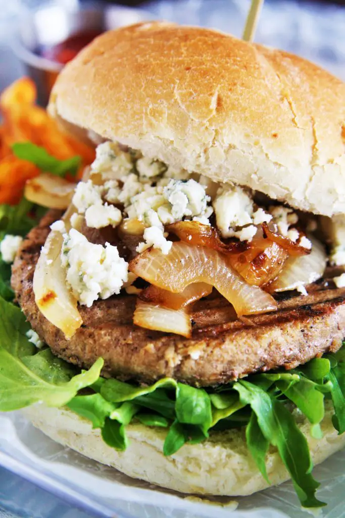 Serve up these savory turkey burgers topped with caramelized onions, blue cheese, and garlic aioli on your next grill night!