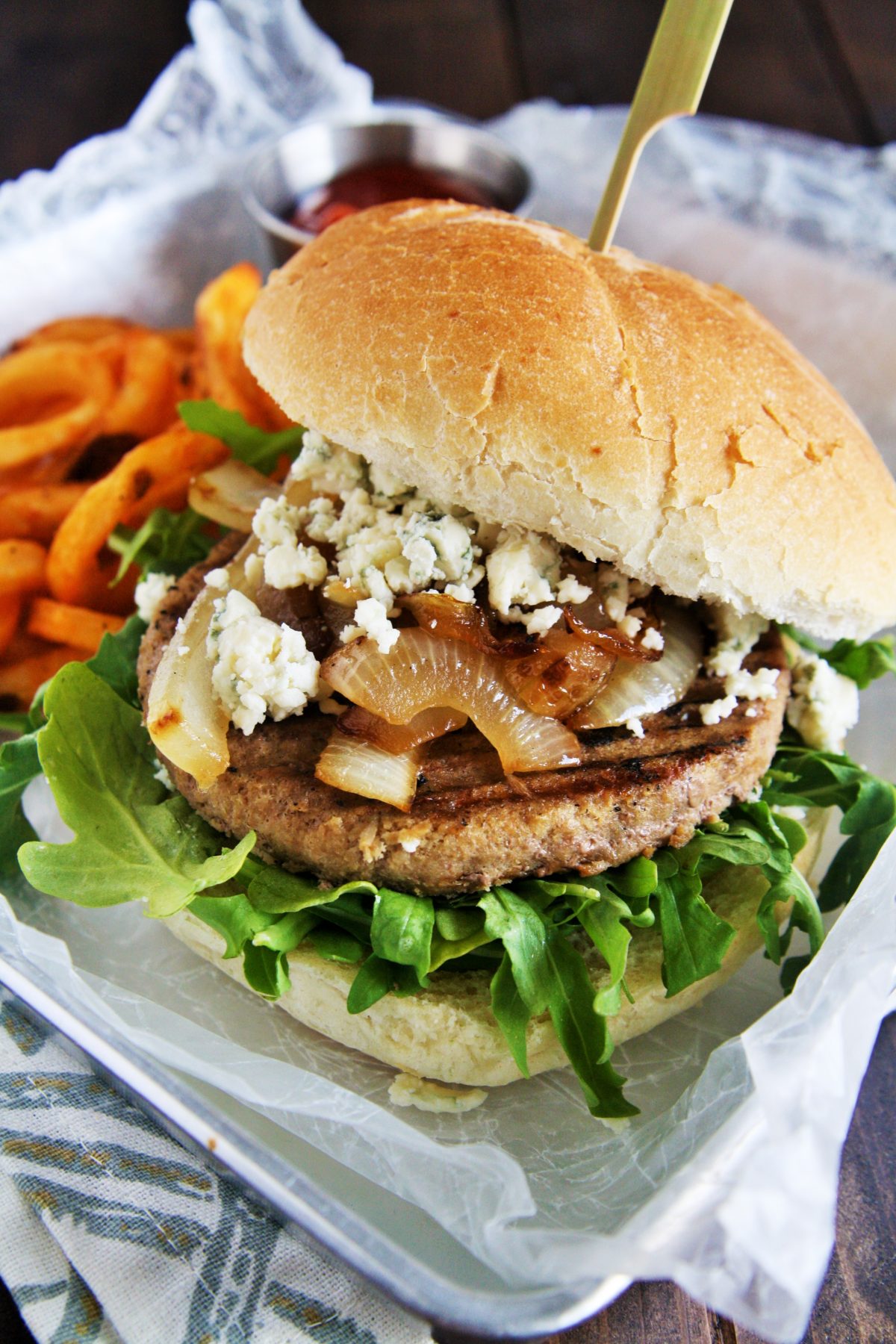 Serve up these savory turkey burgers topped with caramelized onions, blue cheese, and garlic aioli on your next grill night!