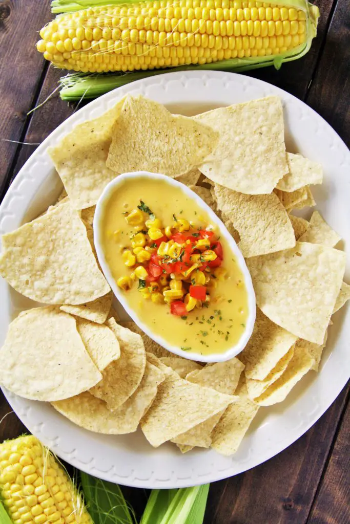 This creamy, velvety smooth queso dip is loaded with fire roasted corn and green chile - guaranteed to be devoured by all!