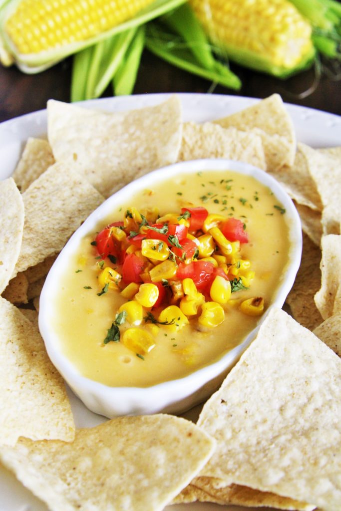 This creamy, velvety smooth queso dip is loaded with fire roasted corn and green chile - guaranteed to be devoured by all!