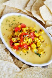 This creamy, velvety smooth queso dip is loaded with fire roasted corn and green chile - guaranteed to be devoured by all!