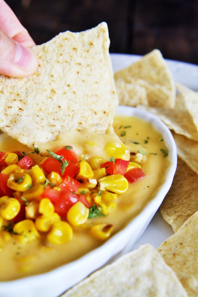 This creamy, velvety smooth queso dip is loaded with fire roasted corn and green chile - guaranteed to be devoured by all!