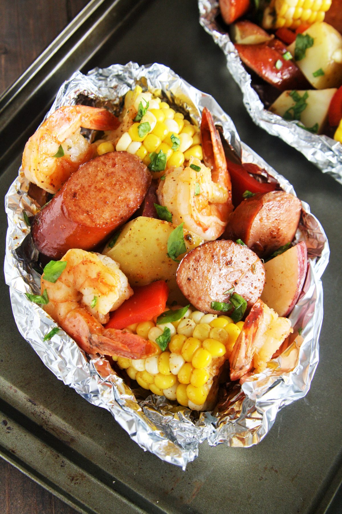 Whether you want an easy weeknight meal at home or looking for a great recipe for the grill, these Cajun Sausage and Shrimp Boil Foil Packets have got you covered. 