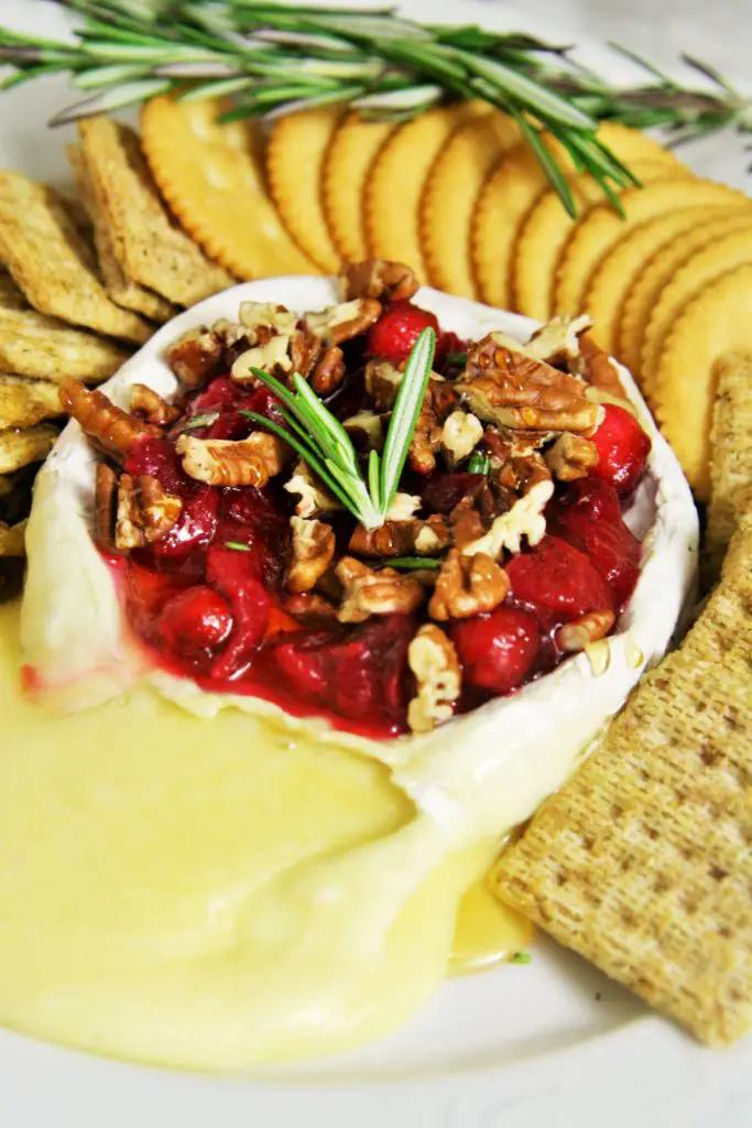 Warm, gooey baked brie topped with tart cranberry sauce, roasted pecans, honey and rosemary. A truly classic appetizer served up for the holidays
