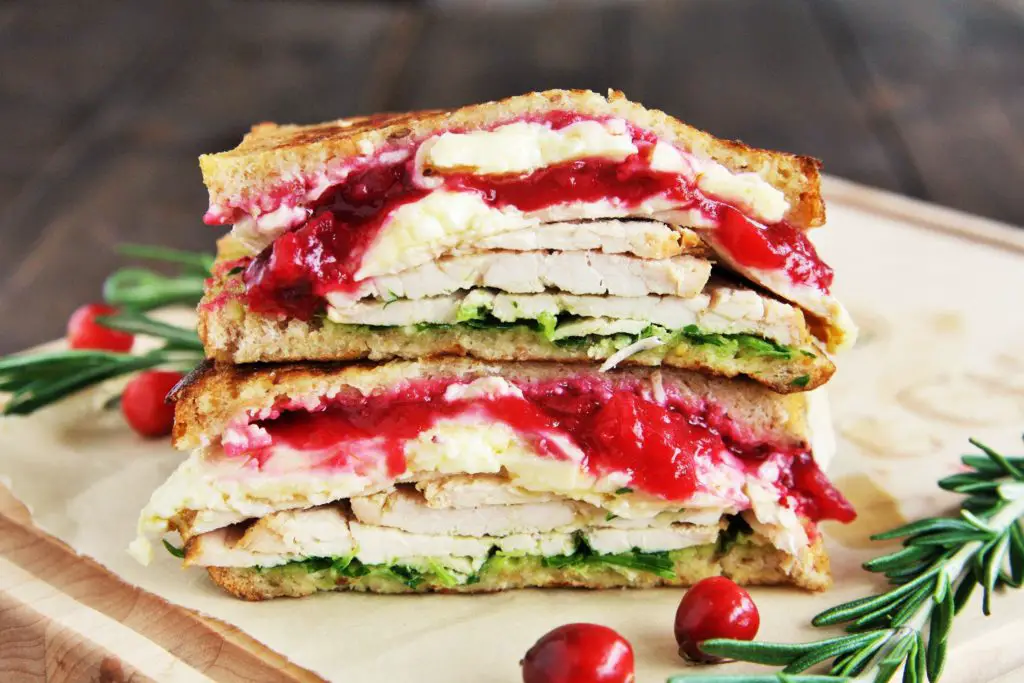 This Turkey and Brie Monte Cristo Sandwich is made with flavorful turkey breast, brie, cranberry sauce, and arugula - use up all those Thanksgiving leftovers or enjoy this all year round!