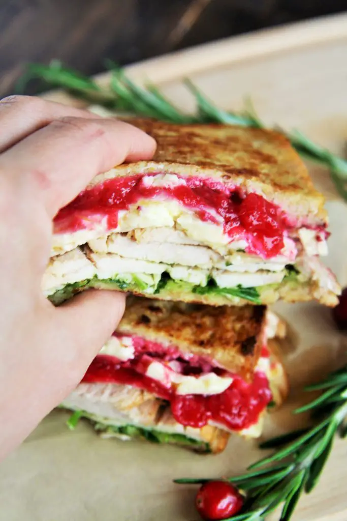 This Turkey and Brie Monte Cristo Sandwich is made with flavorful turkey breast, brie, cranberry sauce, and arugula - use up all those Thanksgiving leftovers or enjoy this all year round!