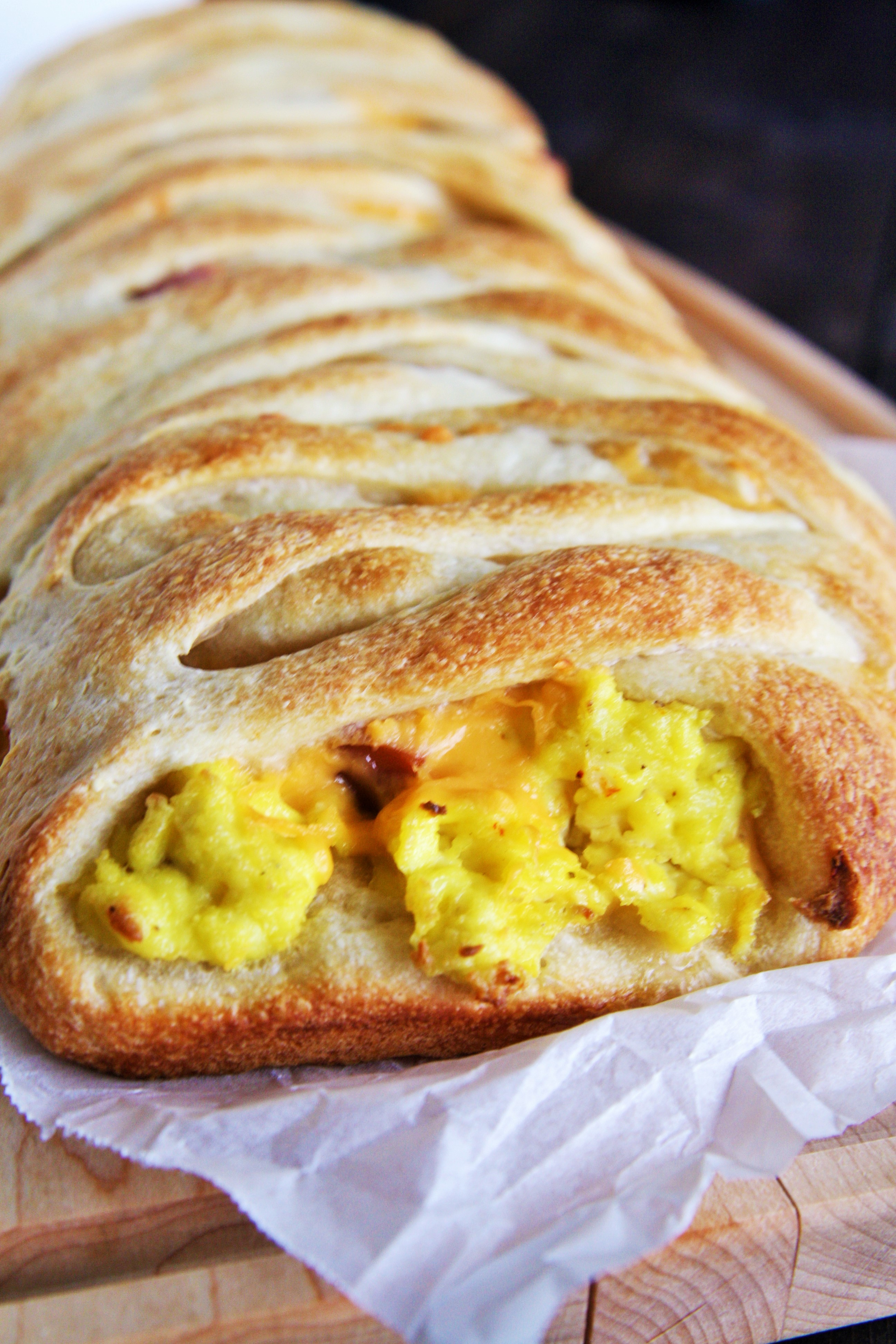 This Ham, Egg, and Cheddar Breakfast Braid is loaded with scrambled eggs, diced ham, peppers, and lots of cheese - perfect for serving a crowd!