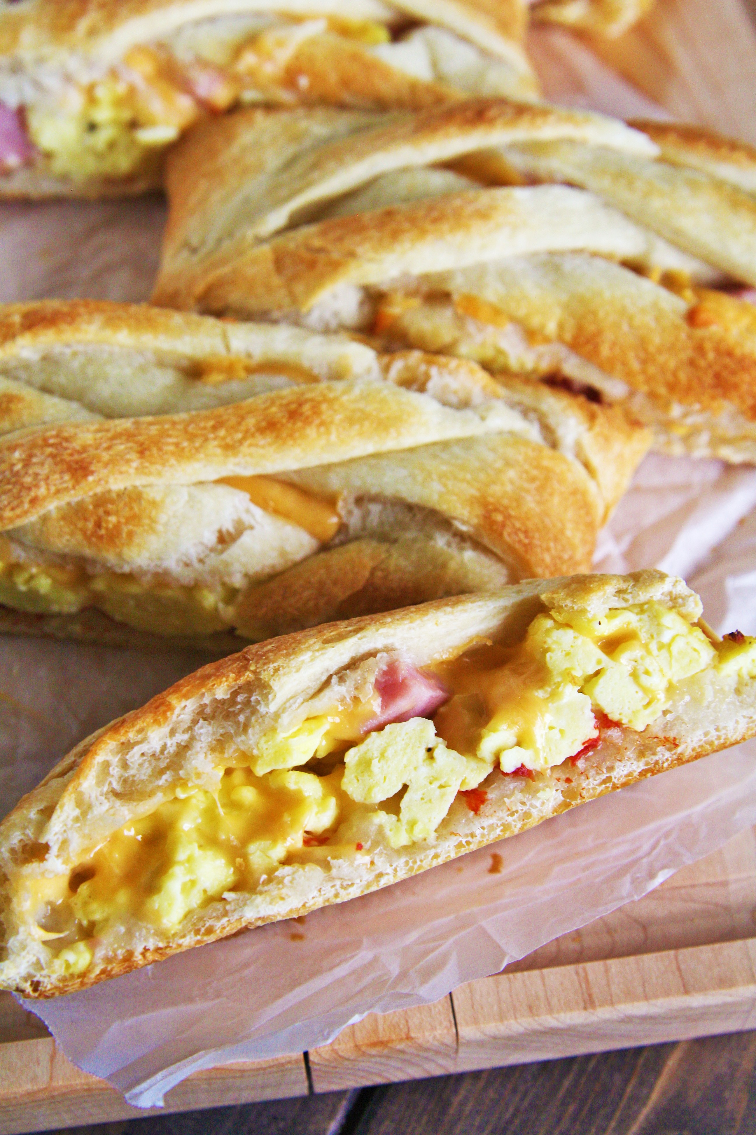 This Ham, Egg, and Cheddar Breakfast Braid is loaded with scrambled eggs, diced ham, peppers, and lots of cheese - perfect for serving a crowd!