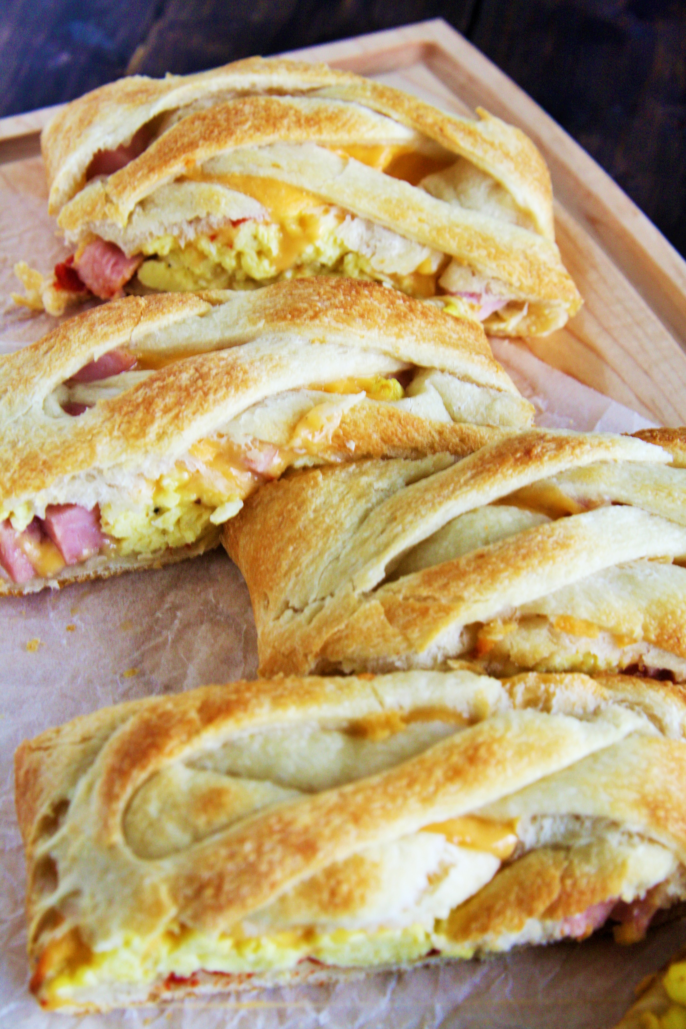 This Ham, Egg, and Cheddar Breakfast Braid is loaded with scrambled eggs, diced ham, peppers, and lots of cheese - perfect for serving a crowd!