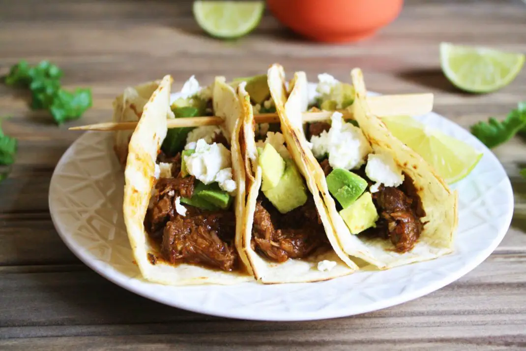 Cooked in the Instant Pot with chipotle peppers, spices, and beer until the meat becomes tender, this Instant Pot beef barbacoa recipe is the perfect filling for burritos, enchilada, tacos, and more! It's quick and easy - perfect for weeknight meal!