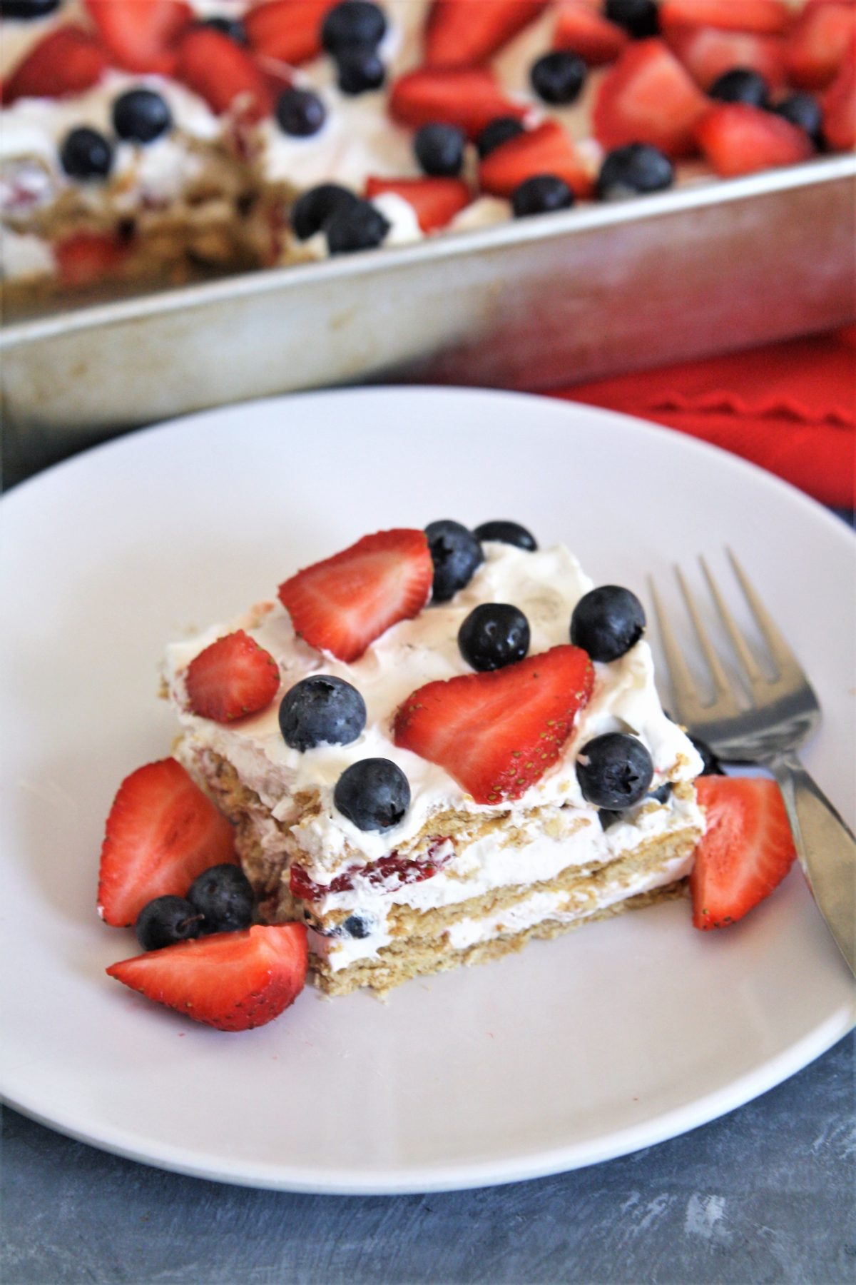 This no-bake Red, White, and Blue Icebox Cake is made with 5 simple ingredients, and is a patriotic dessert perfect for Memorial Day or Fourth of July!