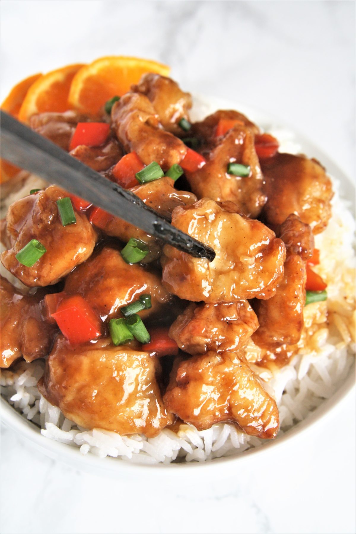 Crispy pieces of fried chicken coated in a delicious sweet and sticky orange sauce, this Panda Express Copycat Orange Chicken will become your new favorite weeknight dinner option!
