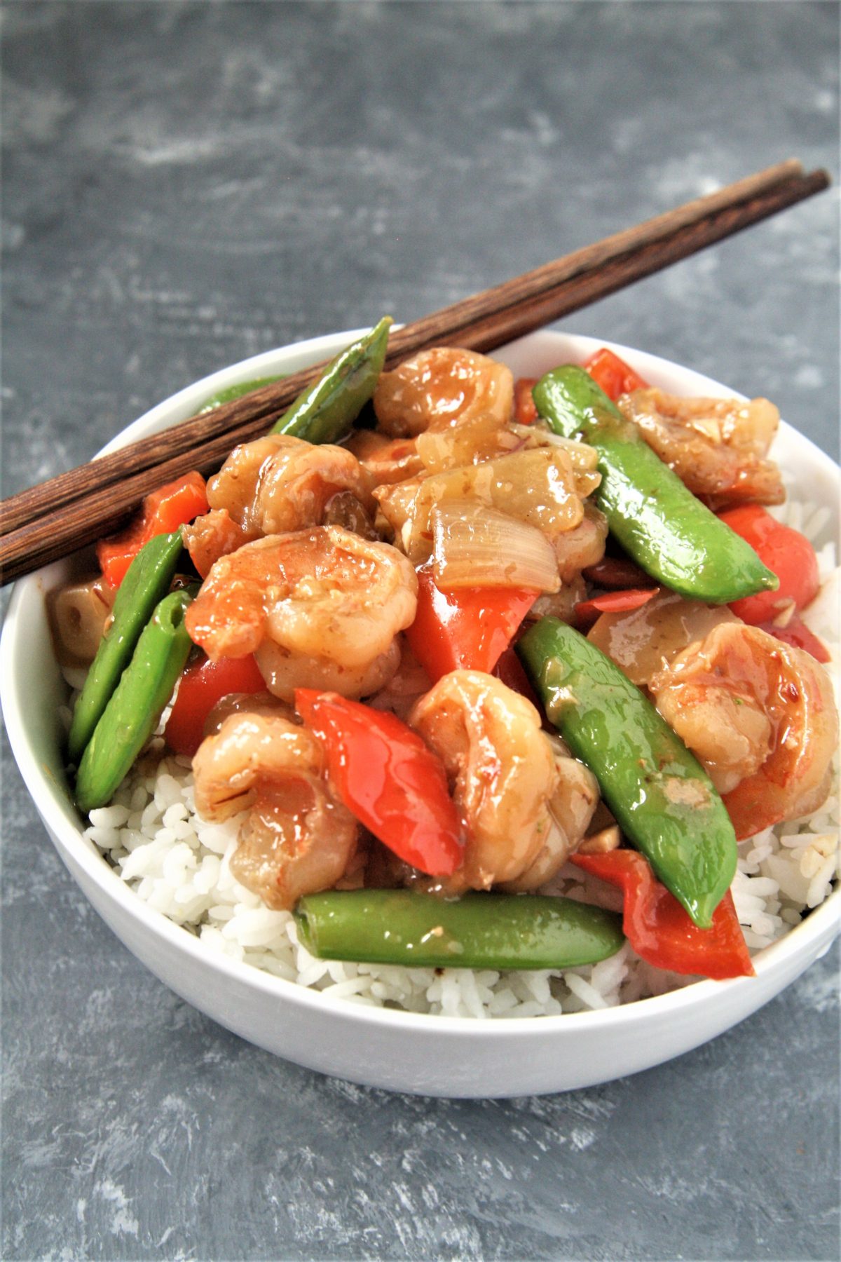 Tender shrimp wok fried in a sweet and spicy sauce with fresh veggies, this Panda Express Copycat Wok-Fried Shrimp recipe is going to quickly become your favorite go-to easy dinner! Serve over rice for a perfect weeknight meal.