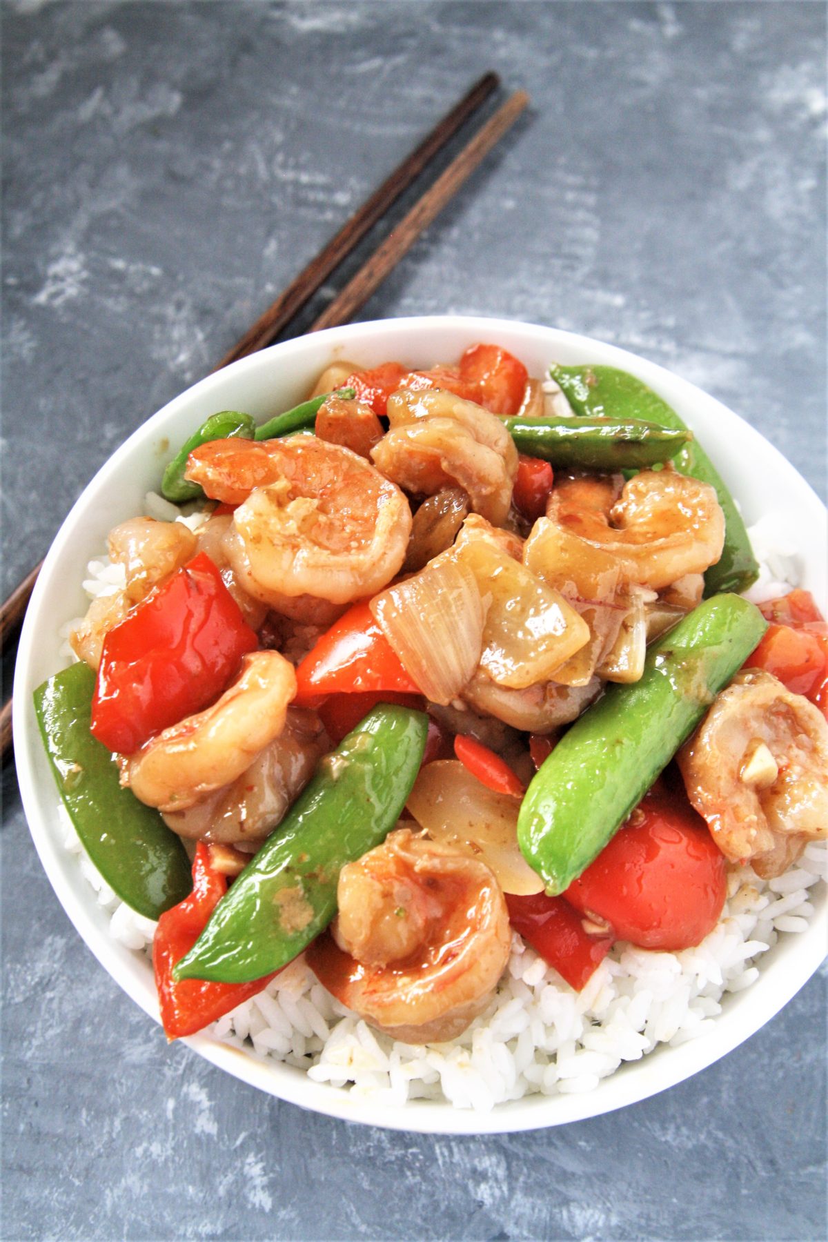 Tender shrimp wok fried in a sweet and spicy sauce with fresh veggies, this Panda Express Copycat Wok-Fried Shrimp recipe is going to quickly become your favorite go-to easy dinner! Serve over rice for a perfect weeknight meal.