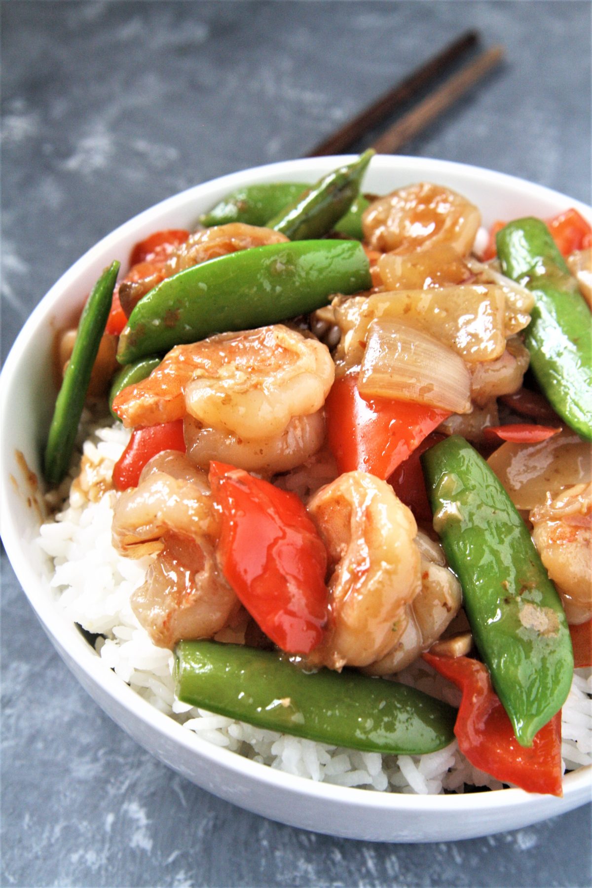 Tender shrimp wok fried in a sweet and spicy sauce with fresh veggies, this Panda Express Copycat Wok-Fried Shrimp recipe is going to quickly become your favorite go-to easy dinner! Serve over rice for a perfect weeknight meal.