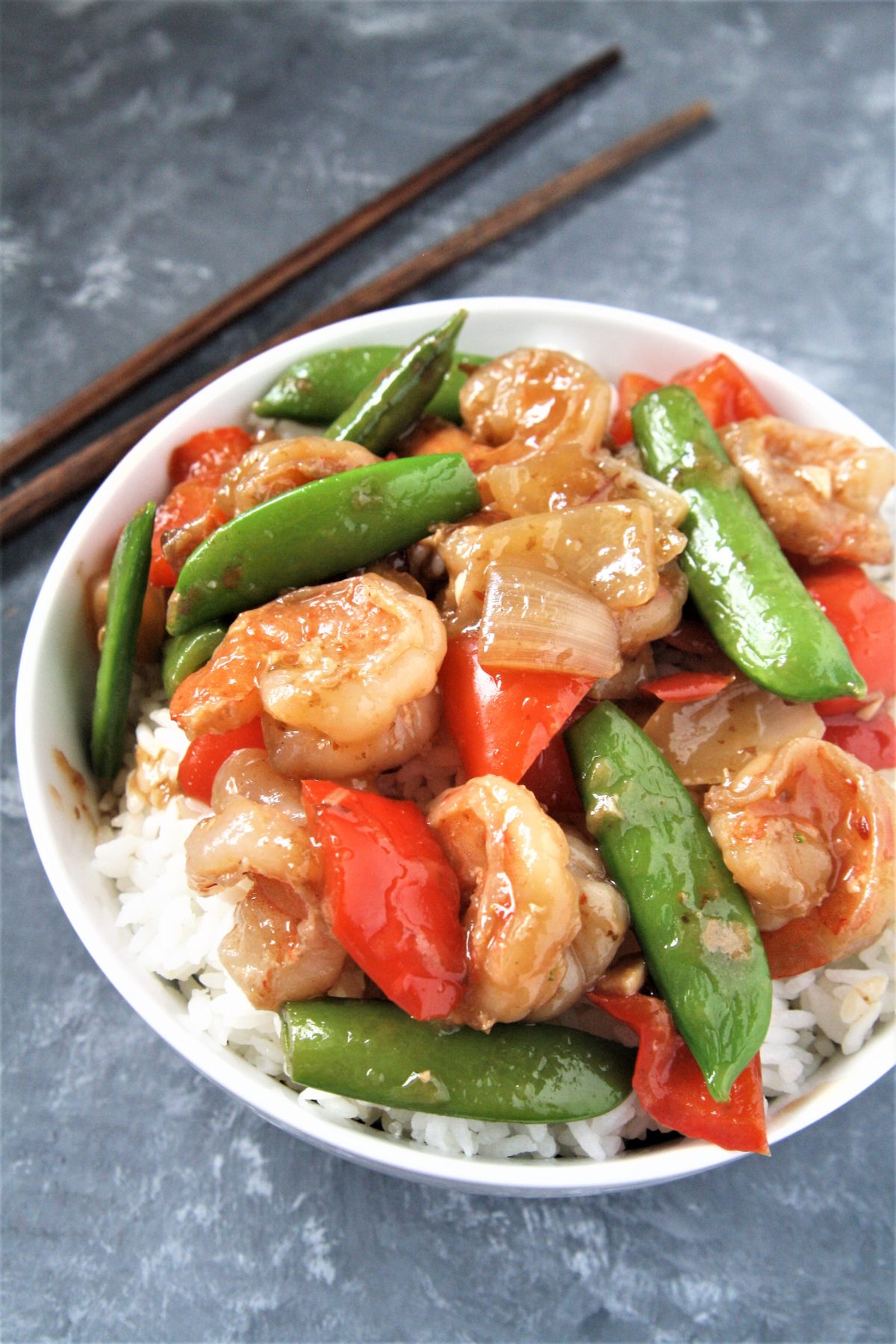 Tender shrimp wok fried in a sweet and spicy sauce with fresh veggies, this Panda Express Copycat Wok-Fried Shrimp recipe is going to quickly become your favorite go-to easy dinner! Serve over rice for a perfect weeknight meal.