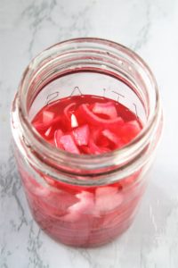 These quick and easy pickled red onions are the perfect condiment to add a bright pop of sweet and tangy flavor to salads, sandwiches, hot dogs, grilled meats, and more.