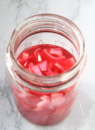 These quick and easy pickled red onions are the perfect condiment to add a bright pop of sweet and tangy flavor to salads, sandwiches, hot dogs, grilled meats, and more.